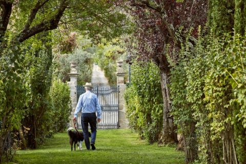 Man with dog garden Villa di Piazzano SLH Luxury Hotel Cortona tuscany